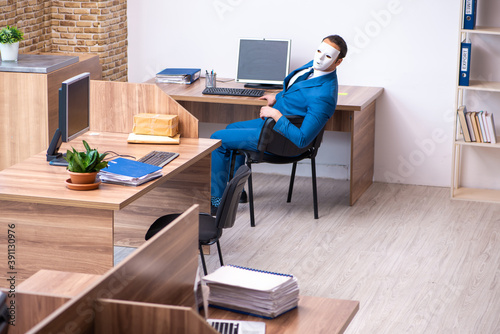 Young male employee wearing mask in the office © Elnur