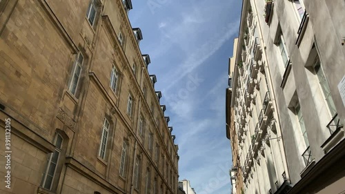 Bottom footage of historical, traditional buildings in Saint-Michel area of Paris showing architectural style of French architecture. It is a sunny summer day. Camera moves forward.