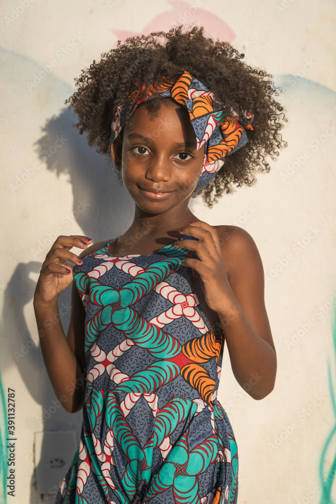 Closeup portrait of Young black girl with afro hairstyle smilling at camera. Closeup portrait of Young black girl with afro hairstyle smilling at camera.