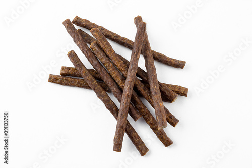 a group of natural formed dog treats, beef, chicken, pork, lamb meat sticks on white background