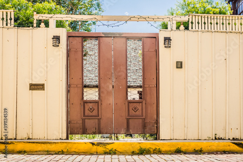 Door in a Wall Along a Sidewalk Leading into a Courtyard.