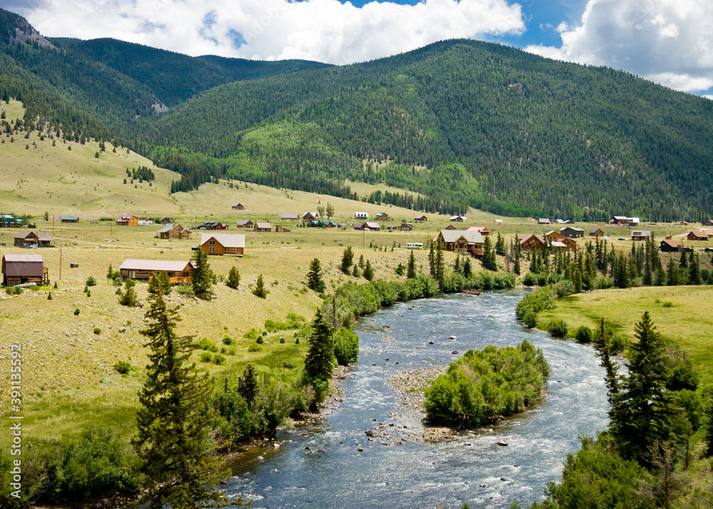 Willow Creek Creed Colorado - Homes along Willow Creek outside the town of Creede in Mineral County Colorado with the forest covered mountains in the background