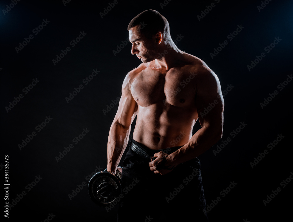 Bodybuilder traininig over black background