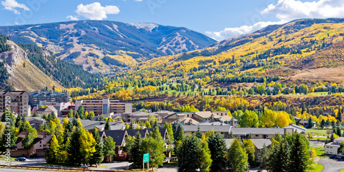 Avon Colorado Autumn scene with gold aspen trees dotting the mountainside photo