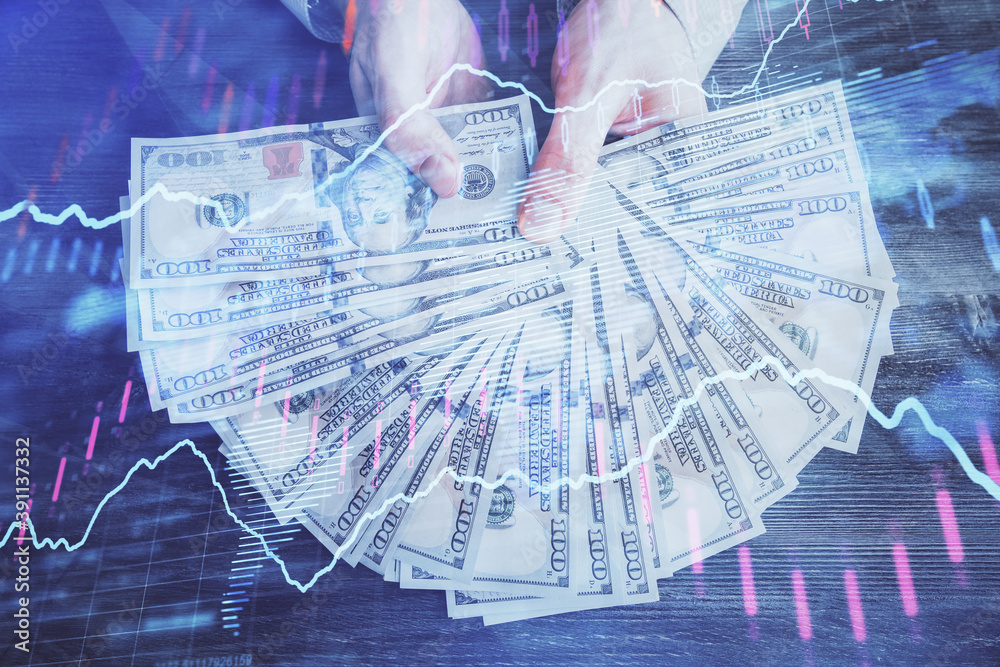 Multi exposure of financial graph drawing hologram and USA dollars bills and man hands. Analysis concept. Multi exposure of financial graph drawing hologram and USA dollars bills and man hands. Analysis concept.