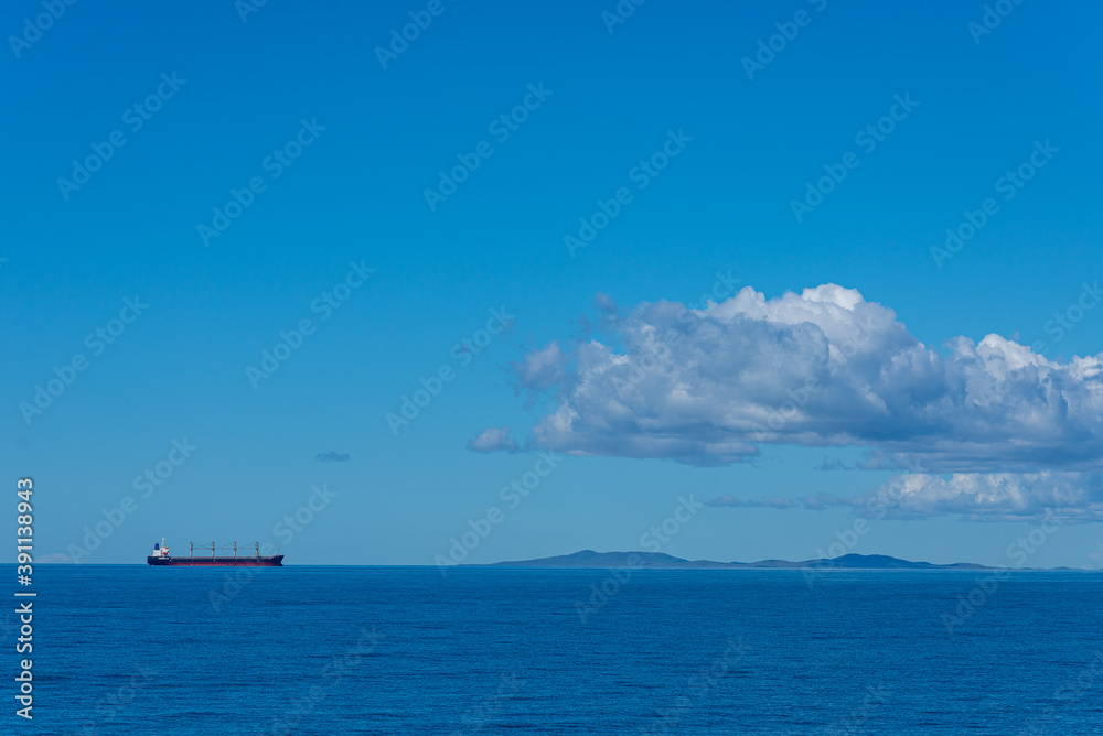 Single cargo ship on ocean Coral Sea