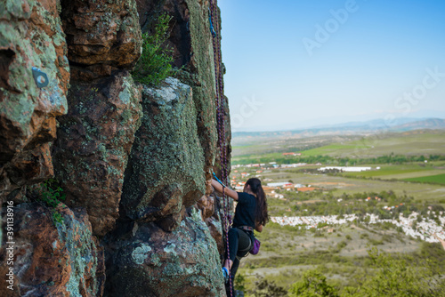 Rock climber climbing up a cliff