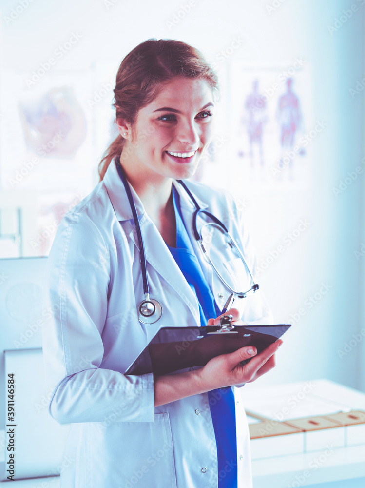Smiling female doctor with a folder in uniform standing Smiling female doctor with a folder in uniform standing