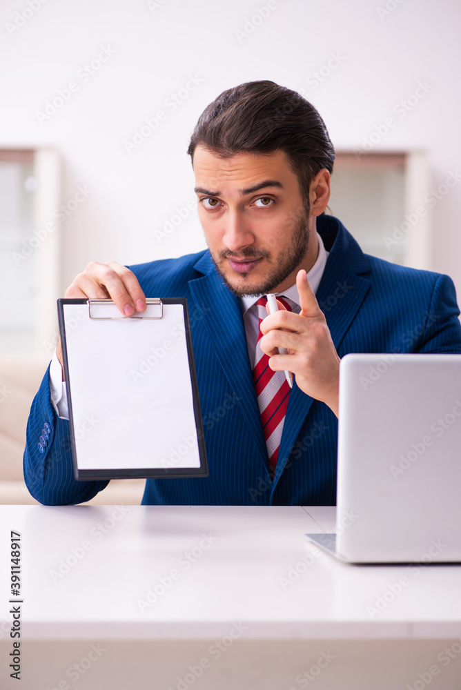 Handsome male realtor working indoors Handsome male realtor working indoors