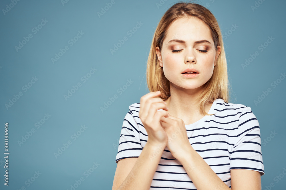 woman wearing striped t-shirt cropped view blue isolated background displeased facial expression woman wearing striped t-shirt cropped view blue isolated background displeased facial expression