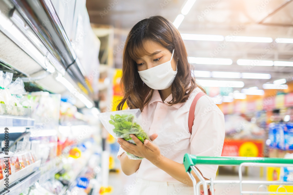 beautiful asian girl wearing facemask protection coronavirus covid-19, shopping trolley buying food water grocery shopping at super store market stocking resource for world pandemic home quarantine beautiful asian girl wearing facemask protection coronavirus covid-19, shopping trolley buying food water grocery shopping at super store market stocking resource for world pandemic home quarantine