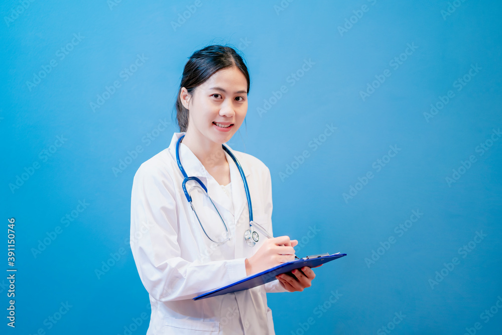 Medical healthcare Asian female attractive doctor using clipboard writing data contract paper files insurance information diagnosing patient medicine health in hospital office blue isolated background Medical healthcare Asian female attractive doctor using clipboard writing data contract paper files insurance information diagnosing patient medicine health in hospital office blue isolated background