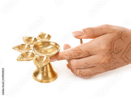 Female hand with diya lamp ...