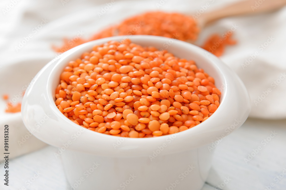 Bowl with raw lentils on table, closeup Bowl with raw lentils on table, closeup