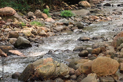 river and rocks. Mountain stream flows between big stones. Stones in the riverbed.