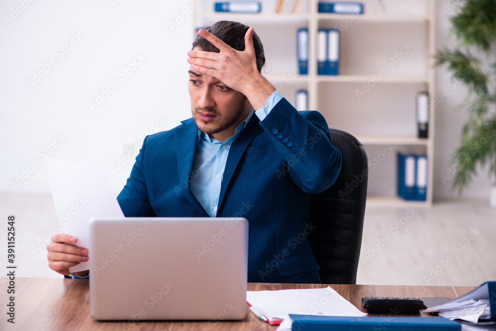 Young male businessman employee working in the office Young male businessman employee working in the office