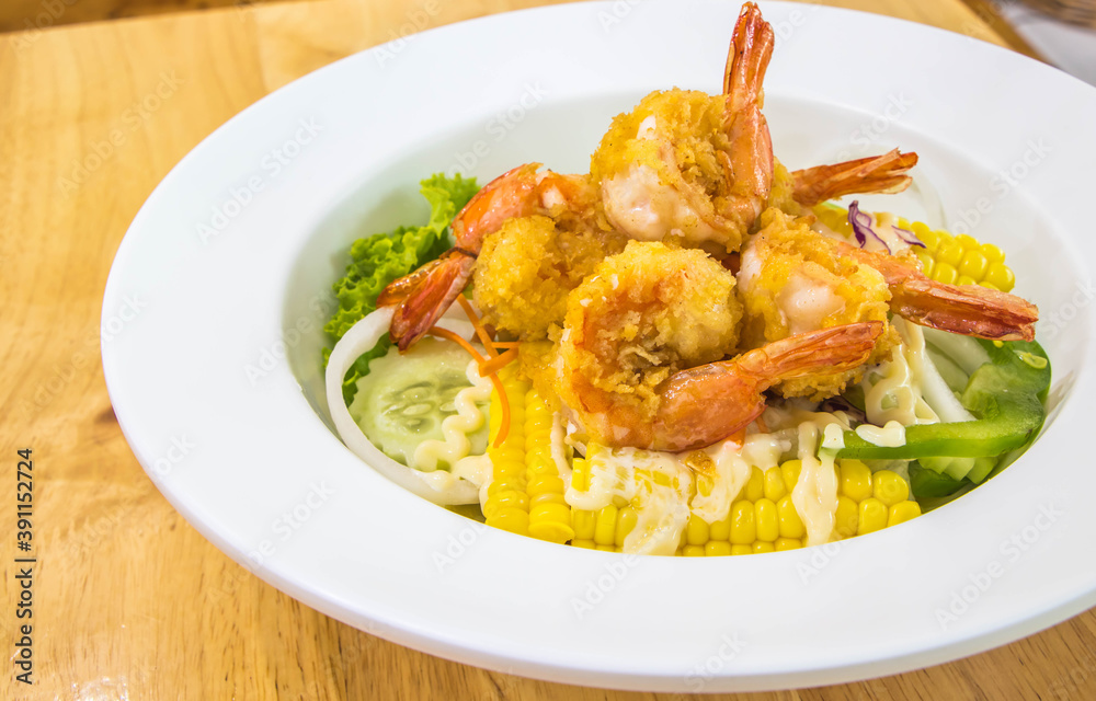 Salad with shrimp, corn,tomatoes,cucumber and mayonnaise in white dish