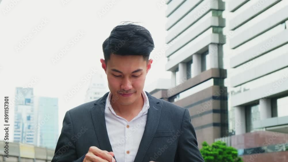 Asian male office worker standing in city with new normal lifestyle. Asian male office worker standing in city with new normal lifestyle.