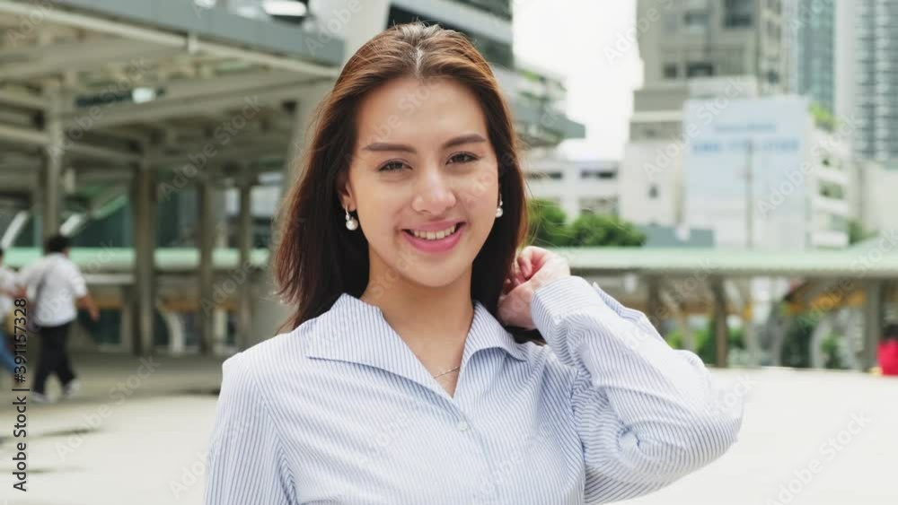 Asian young businesswoman feeling happy and confident standing in city Asian young businesswoman feeling happy and confident standing in city