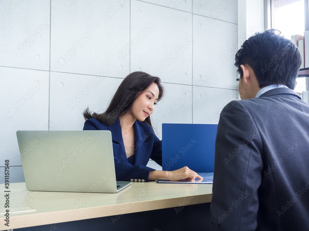 Asian business man and woman wearing suit working together in office. Asian business man and woman wearing suit working together in office.