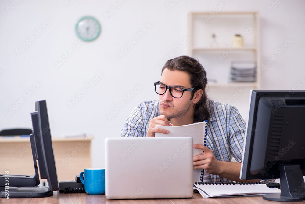 Young male it specialist working in the office Young male it specialist working in the office