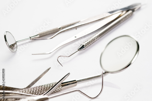 Basic dentist tools on white background.