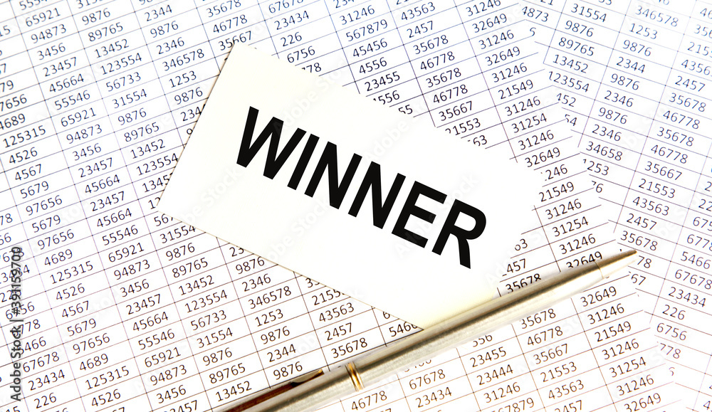 Fototapeta premium On the card the text winner, next to reports, pen.