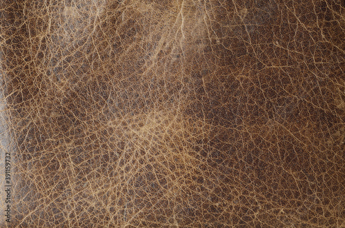 The texture of brown leather that has faded over time.
