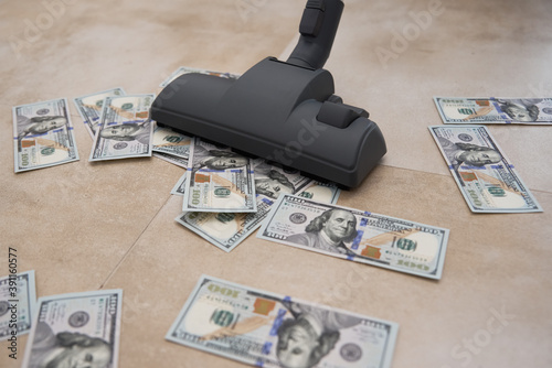 Vacuum cleaner suck usd dollar banknotes. Launder money concept