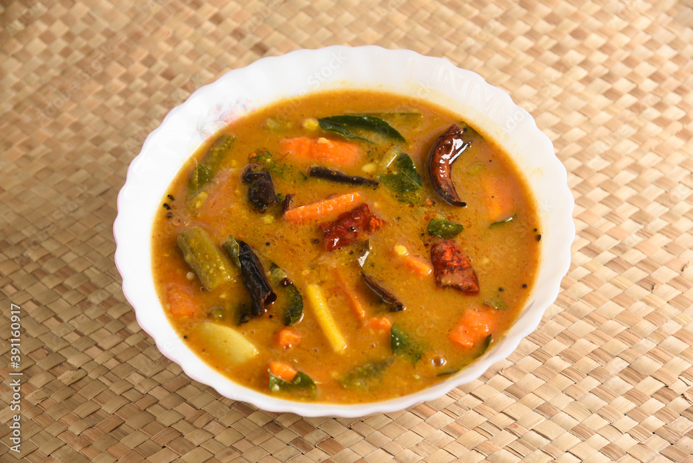 Kerala food for Onam festival special curry Sambar , Sambhar for Onam sadya , sadhya in green banana leaf background. popular Sri Lankan food . South Indian spicy vegetable curry vegan vegetarian dish Kerala food for Onam festival special curry Sambar , Sambhar for Onam sadya , sadhya in green banana leaf background. popular Sri Lankan food . South Indian spicy vegetable curry vegan vegetarian dish