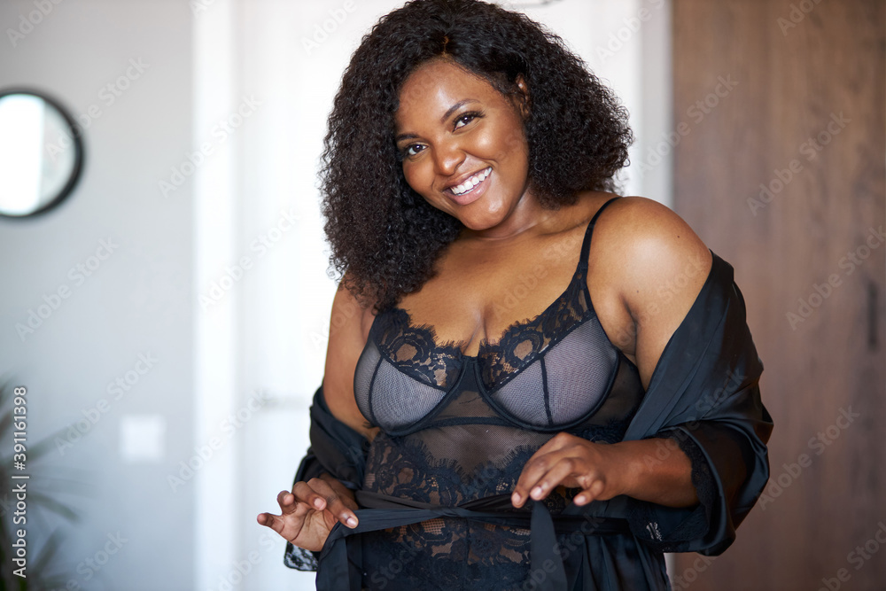 pretty afro american lady in underwear posing indoors, half naked female have sexy plus size body, she is not shy - obrazy, fototapety, plakaty 