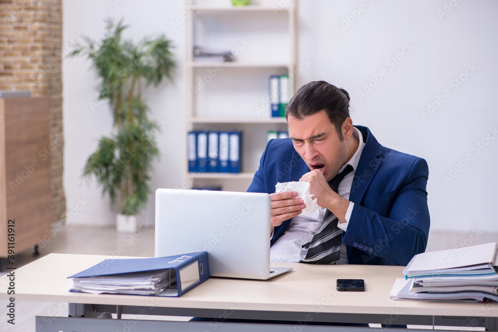 Sick male employee suffering at workplace Sick male employee suffering at workplace