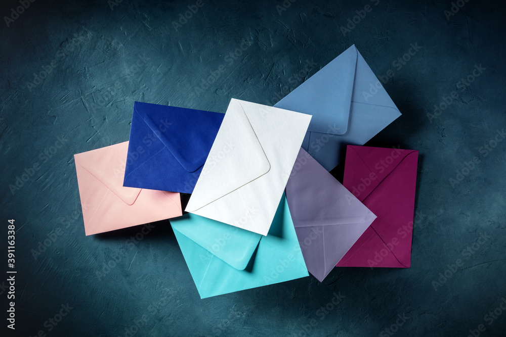 Colourful envelopes flying in the air over a dark blue background, the concept of mail Colourful envelopes flying in the air over a dark blue background, the concept of mail