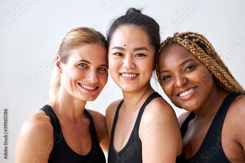 positive cheerful mixed race women posing, smiling at camera isolated on white background
