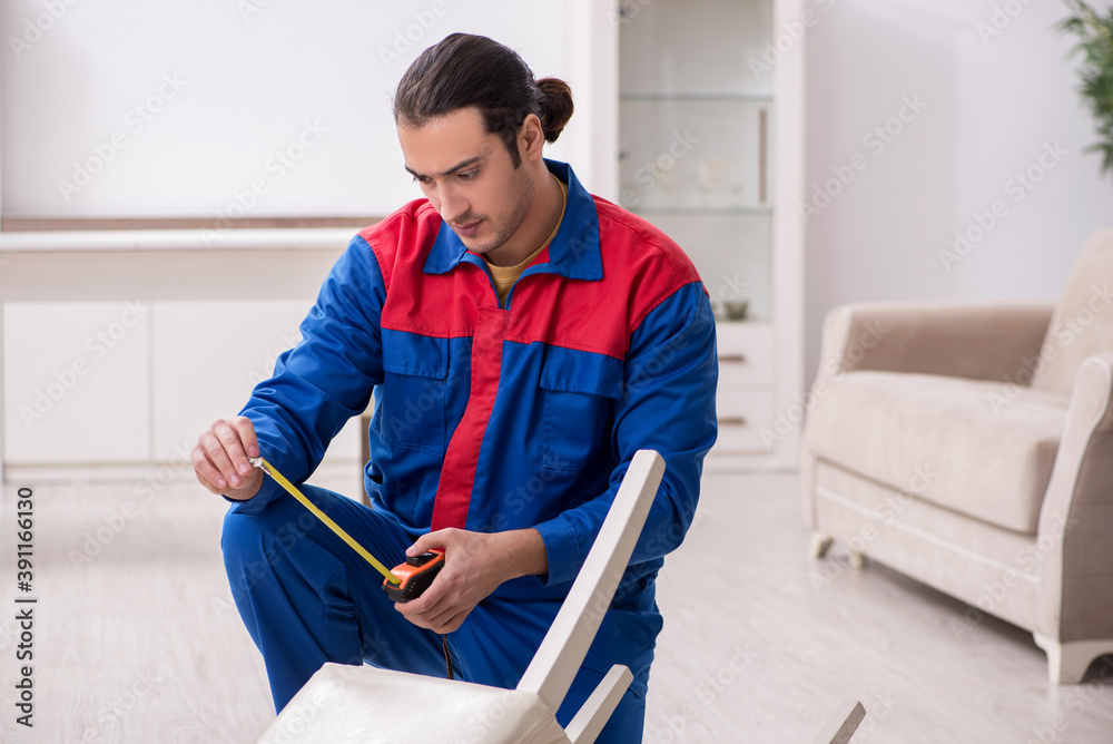 Young male carpenter working indoors