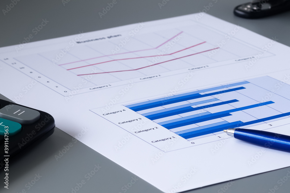 business graph, calculator and pen on gray background business graph, calculator and pen on gray background