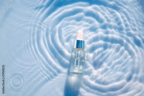 Cuadro en lienzo Cosmetic spa medical skin care, bottle for serum, micellar toner and emulsion on water texture background with splashes