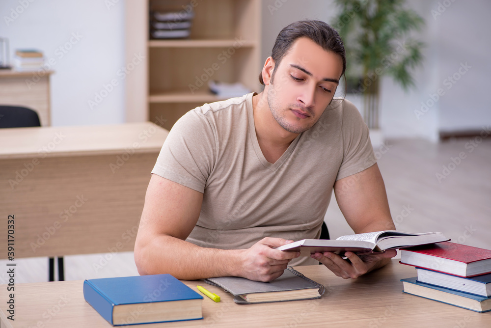 Young male student preparing for exams at library Young male student preparing for exams at library