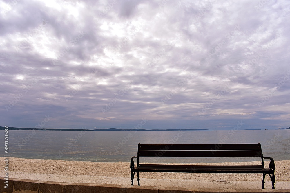 Wooden bench at the beach/ Beautiful sea landscape on winter cloudy day 