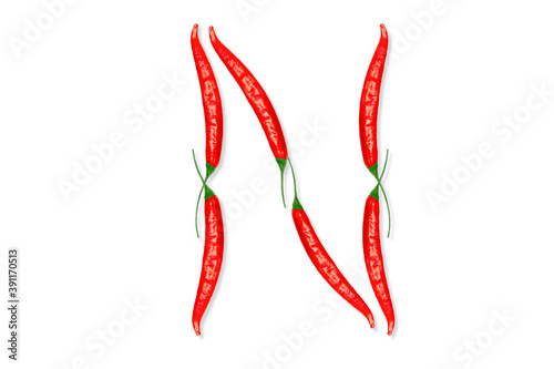 Alphabet letter N made from red hot chili peppers. Letter isolated on white background.