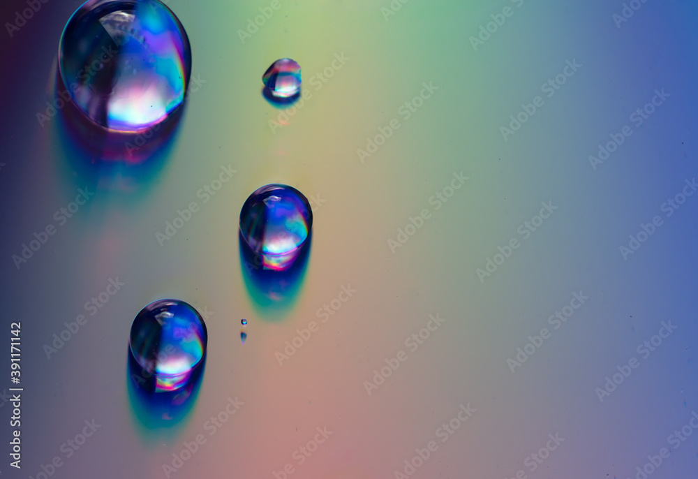 Water drops on a rainbow background. Water drops on a rainbow background.
