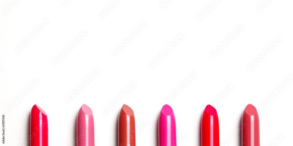 Lipsticks in a row isolated on white background Lipsticks in a row isolated on white background