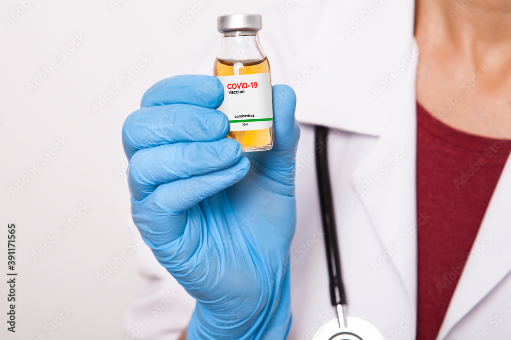 The doctor is holding medicine bottle in his hand. The doctor is holding medicine bottle in his hand.