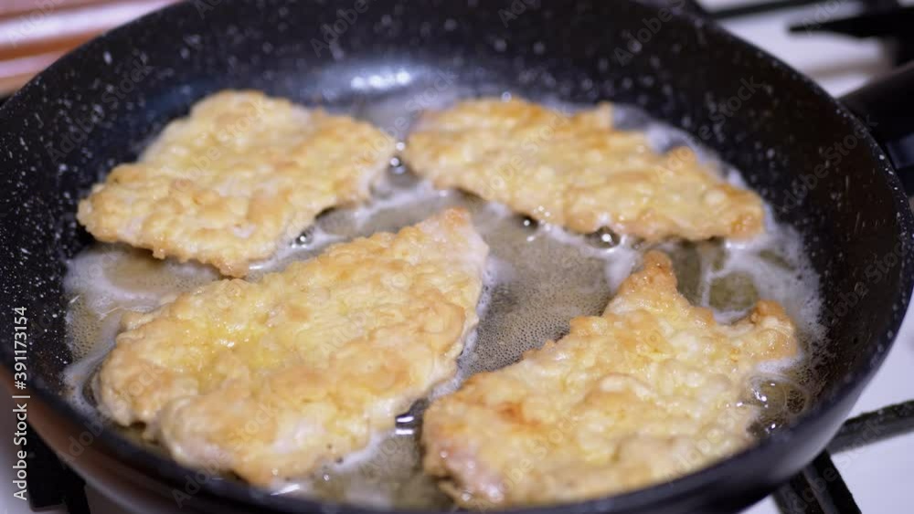 Fried chicken chops with crispy crust in Frying Pan. Home Kitchen. Close-up Fried chicken chops with crispy crust in Frying Pan. Home Kitchen. Close-up