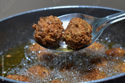 preparing homemade CHINESE fried DRY MANCHURIAN BALLS in vessel photo