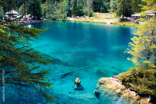 Lake blausee with the mermaid in the foreground, highlighted for being a fairytale lake with crystal clear blue waters and transparent turquoise photo