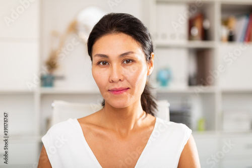 Portrait of a positive asian business woman in the office Free Download Portrait of a positive asian business woman in the office - GFXLoad