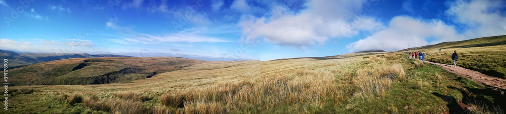 The well maintained path to the summit of Pen y Fan Mountain in the Brecon Beacons National Park - panoramic with blue skies. 