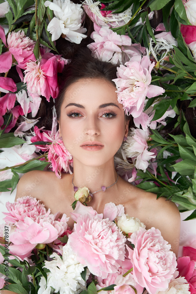 Beautiful woman with lots of pink flowers in her hands. Sexy woman with long hair Beautiful woman with lots of pink flowers in her hands. Sexy woman with long hair