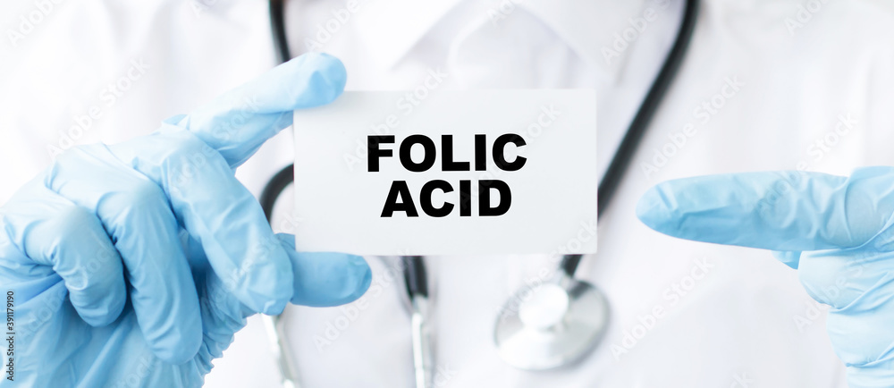 Doctor holding a card with text Folic Acid, Medical concept Doctor holding a card with text Folic Acid, Medical concept